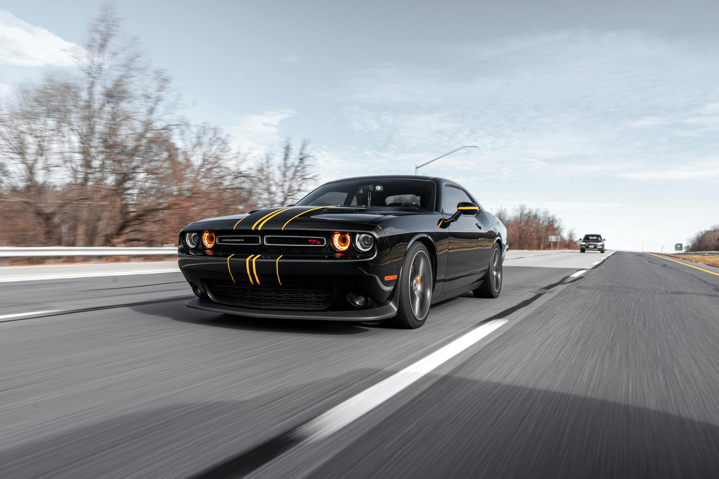 A black car speeding on a highway